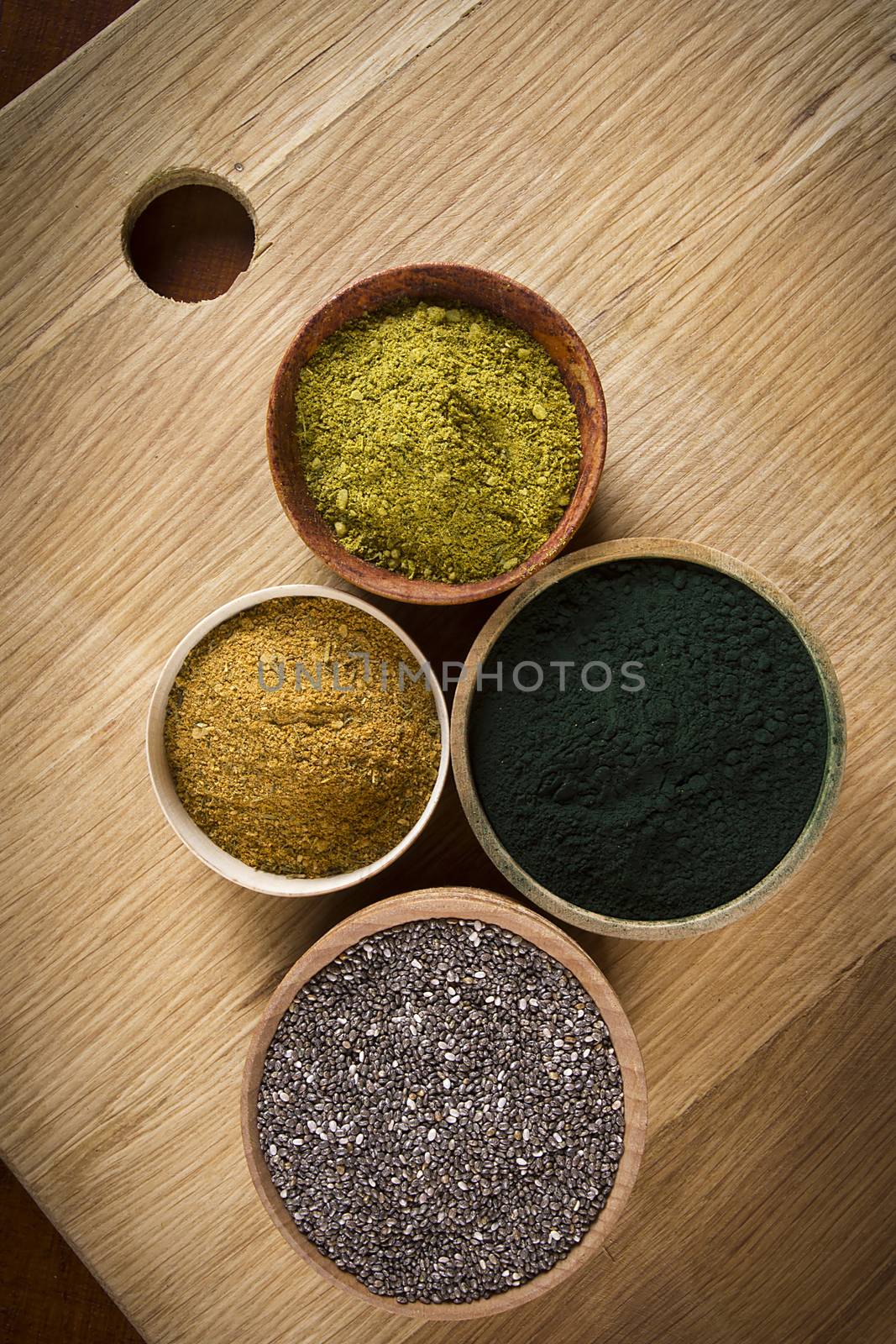 Various superfoods in wooden small dishes on the table