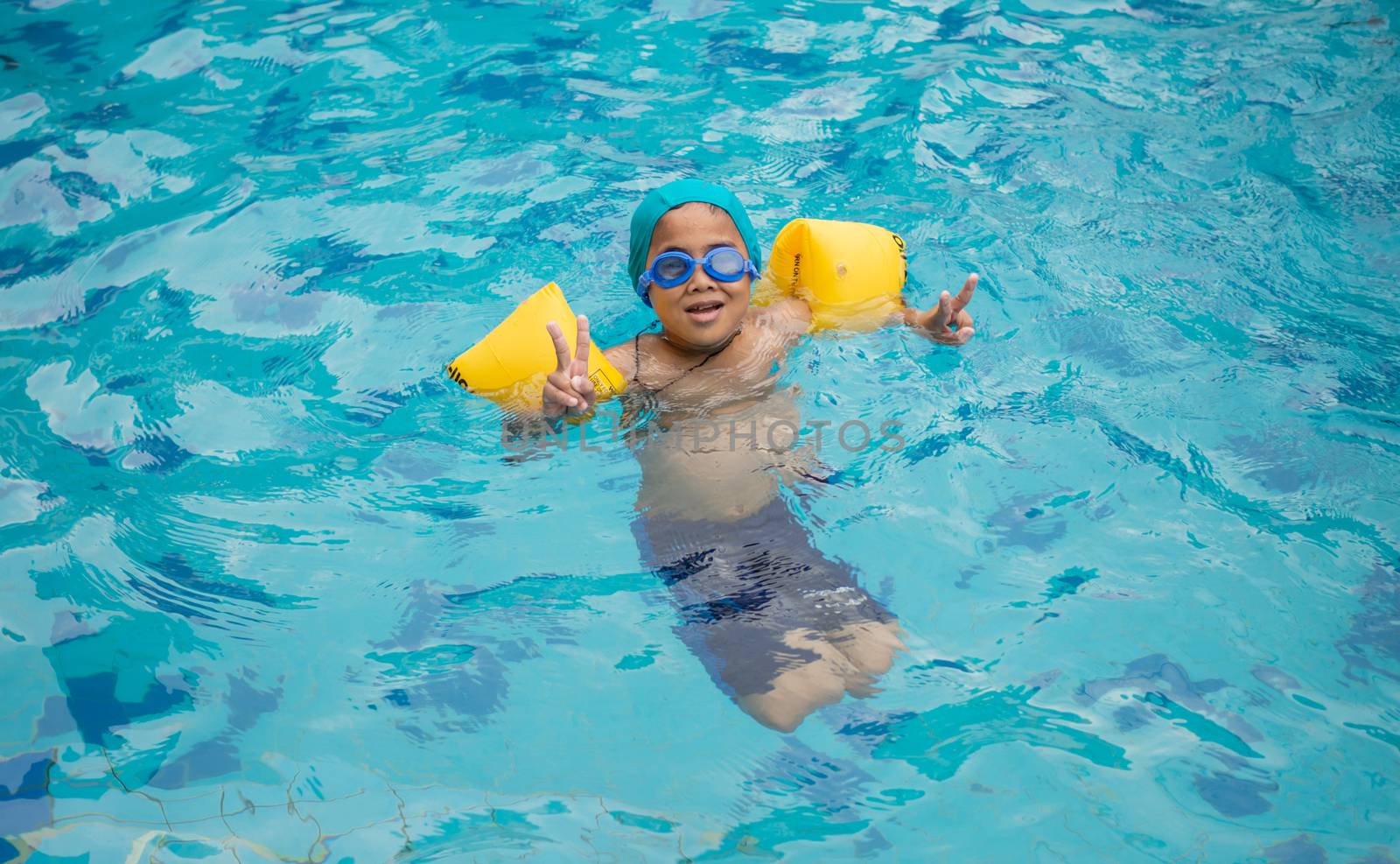 Boy practicing swimming in the pool