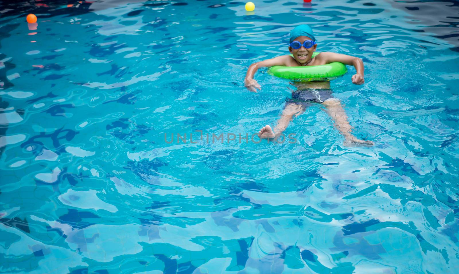 Boy practicing swimming in the pool