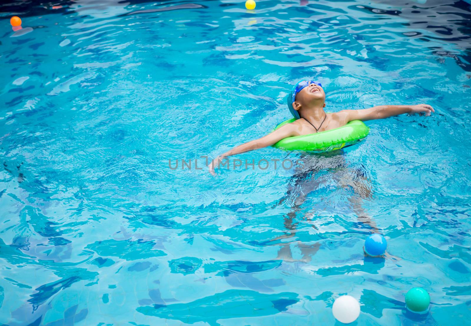 Boy practicing swimming in the pool