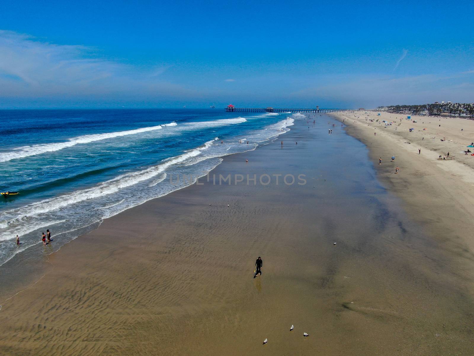 Aerial view of Huntington Beach and coastline during hot blue sunny summer day, Southeast of Los Angeles. California. destination for holiday and surfer