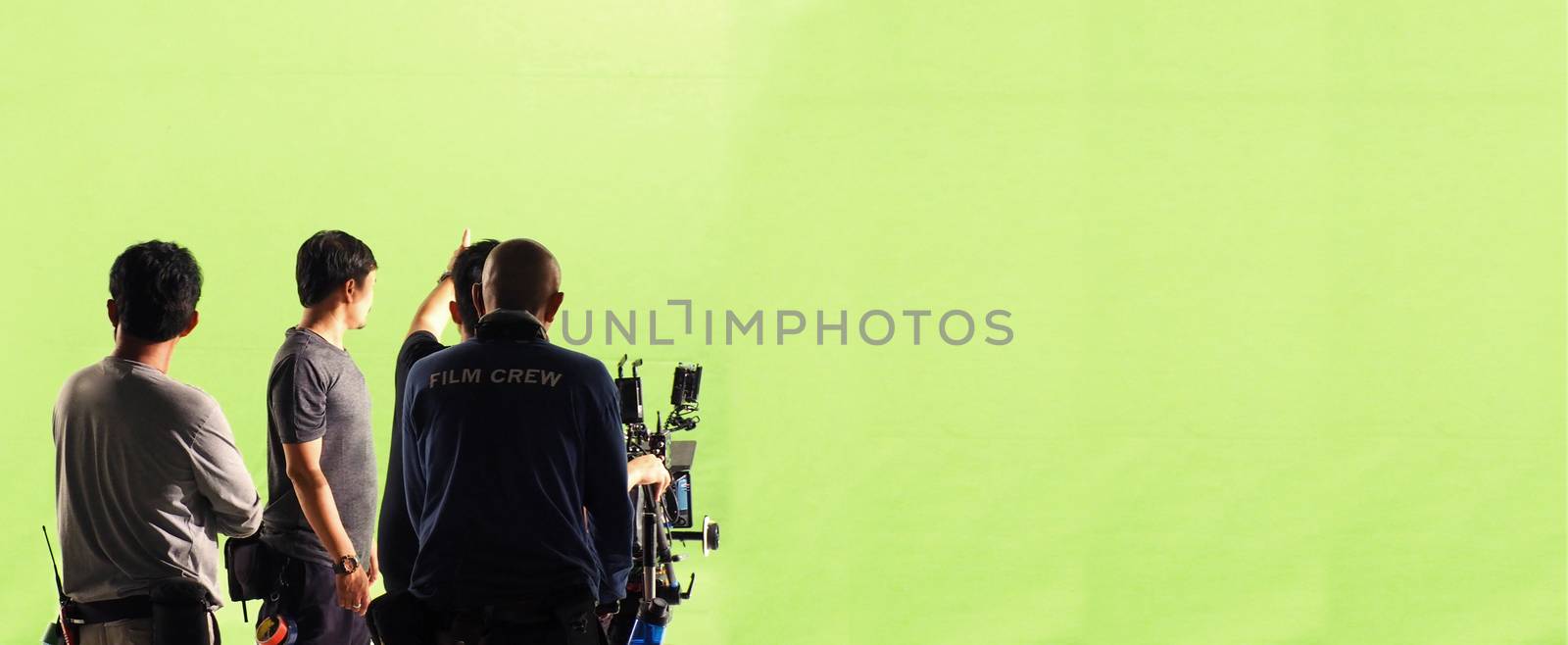 Camera and green screen studio in panorama view and man working or shooting or recording or filming.