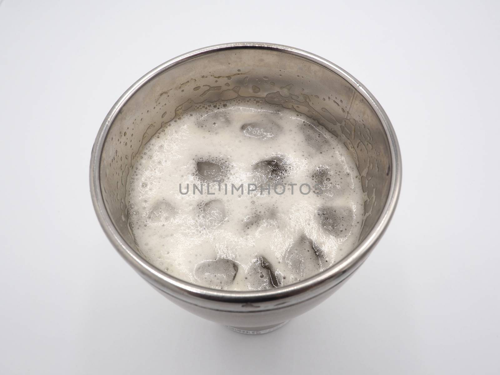 White beer foam bubbles and ice cubes close-up. by gnepphoto