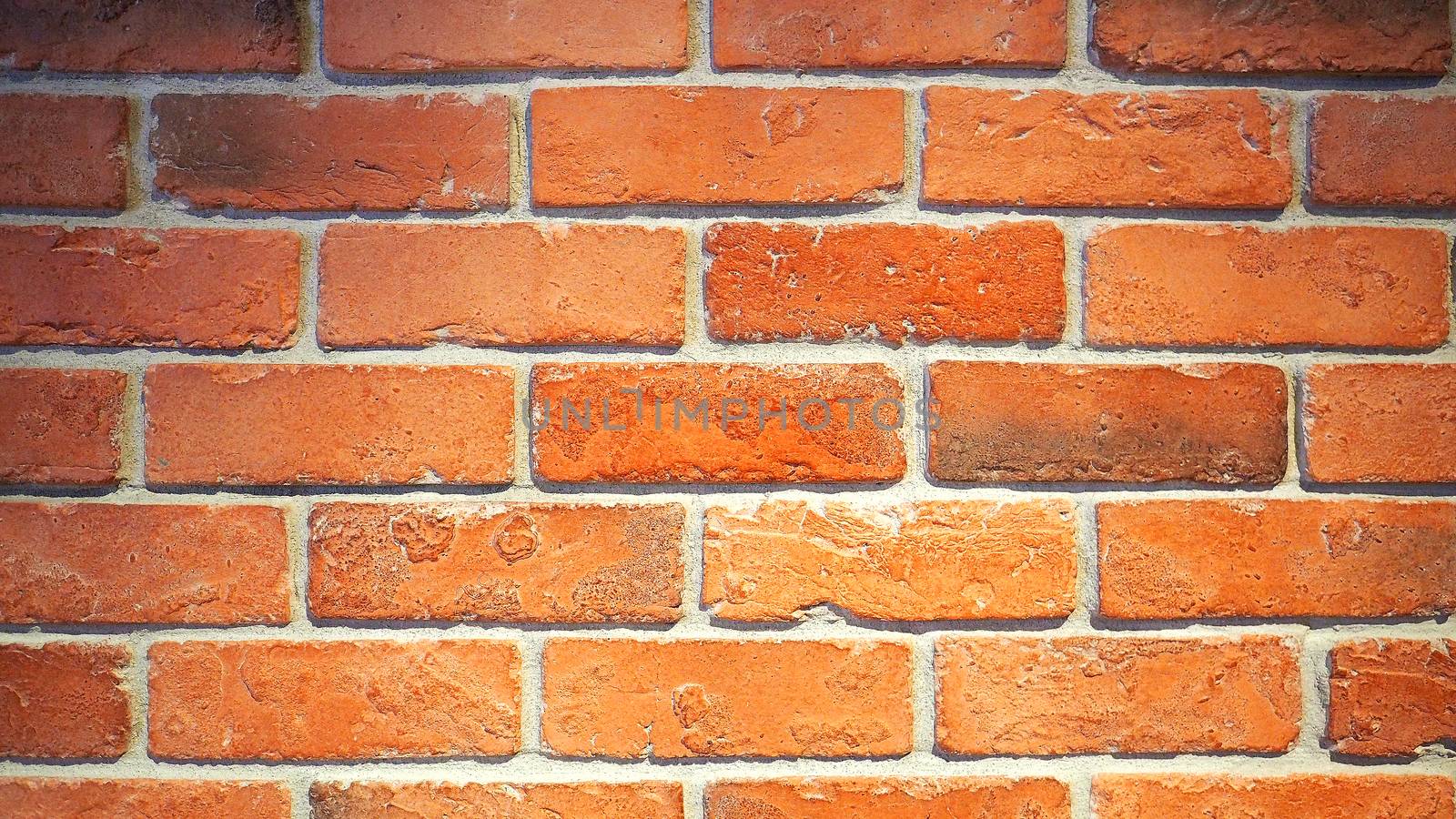 Red brick wall and old dirty rough surface texture close-up.