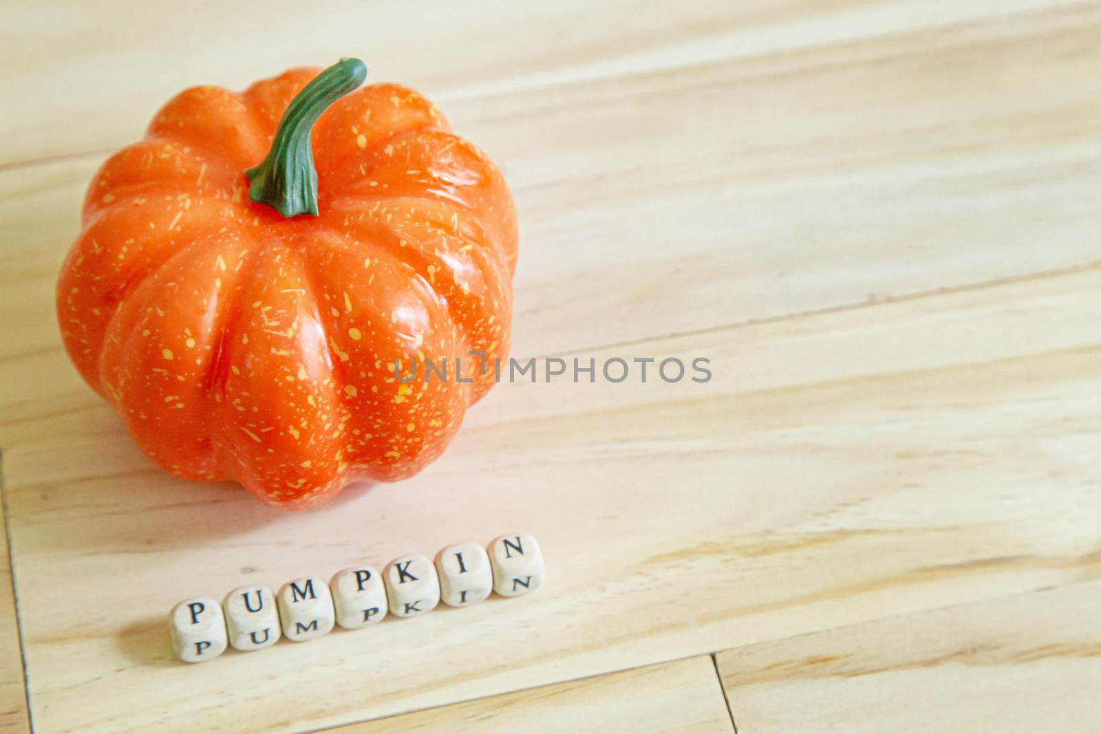 The pumpkin toy on wood table for food content.