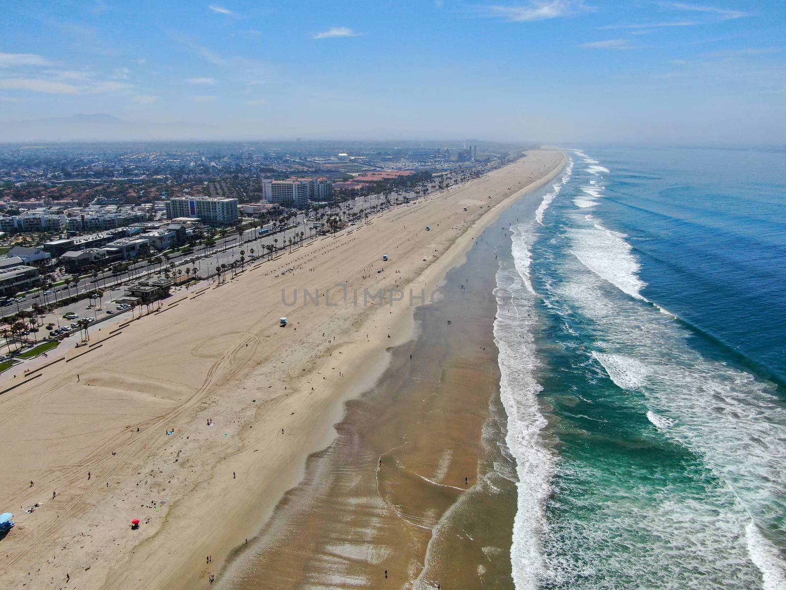 Aerial view of Huntington Beach and coastline during hot blue sunny summer day by Bonandbon