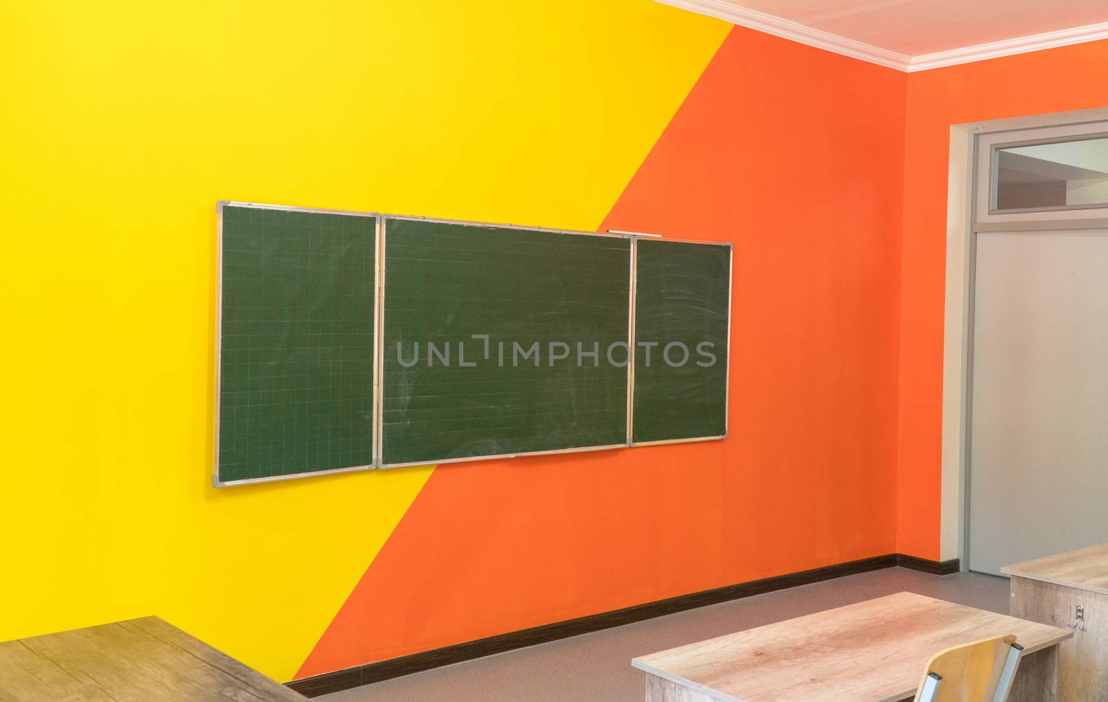 An empty school classroom with a blackboard. Interior of a school classroom