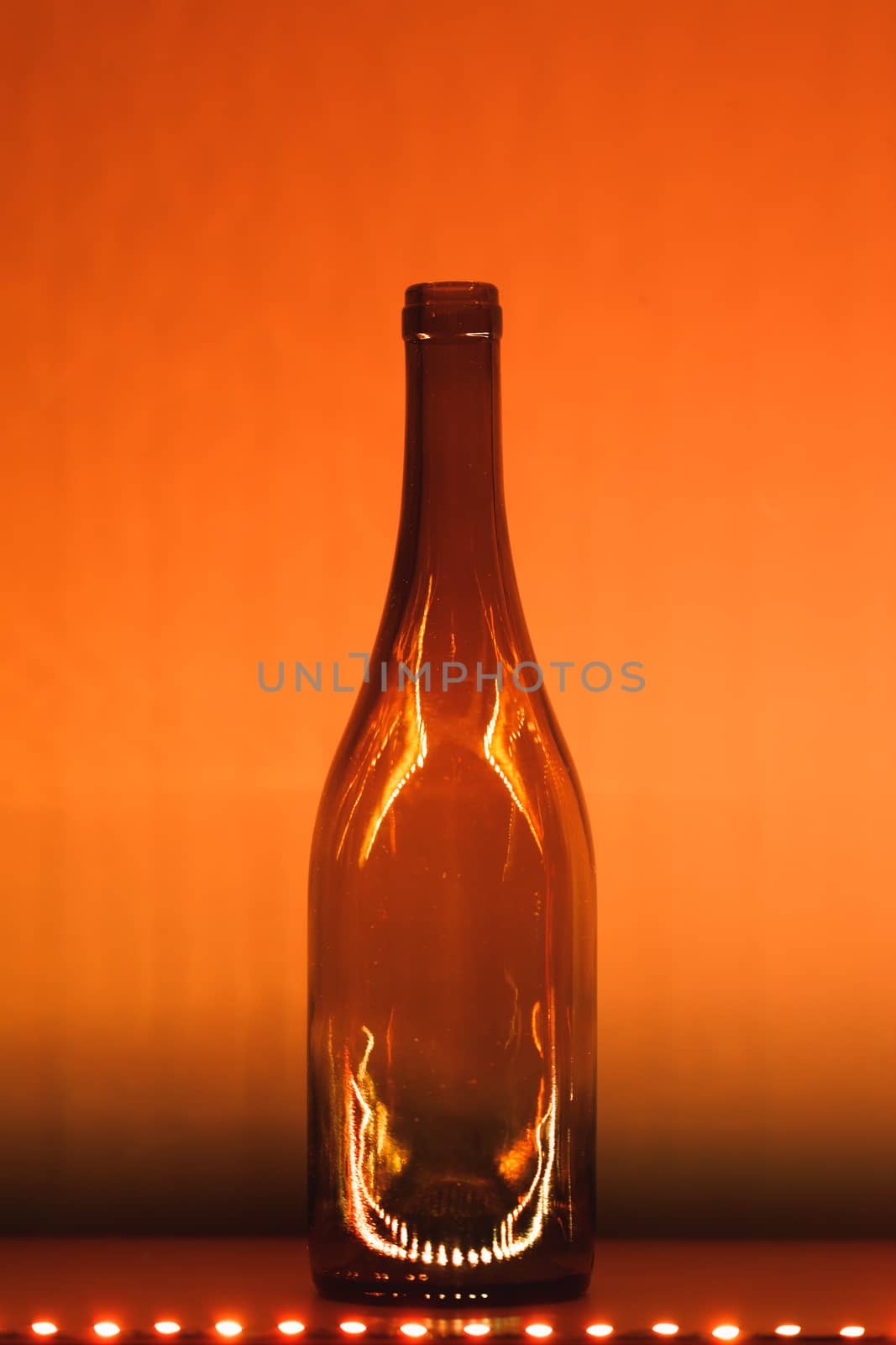 abstract empty wine bottle with orange led illumination
