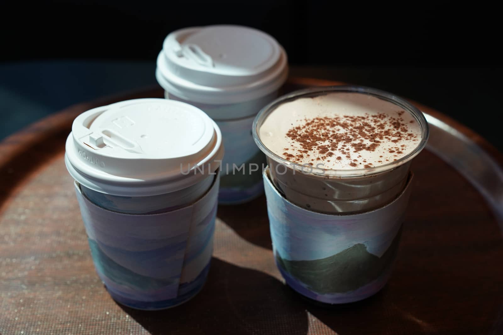 Three cups of coffee on wooden tray