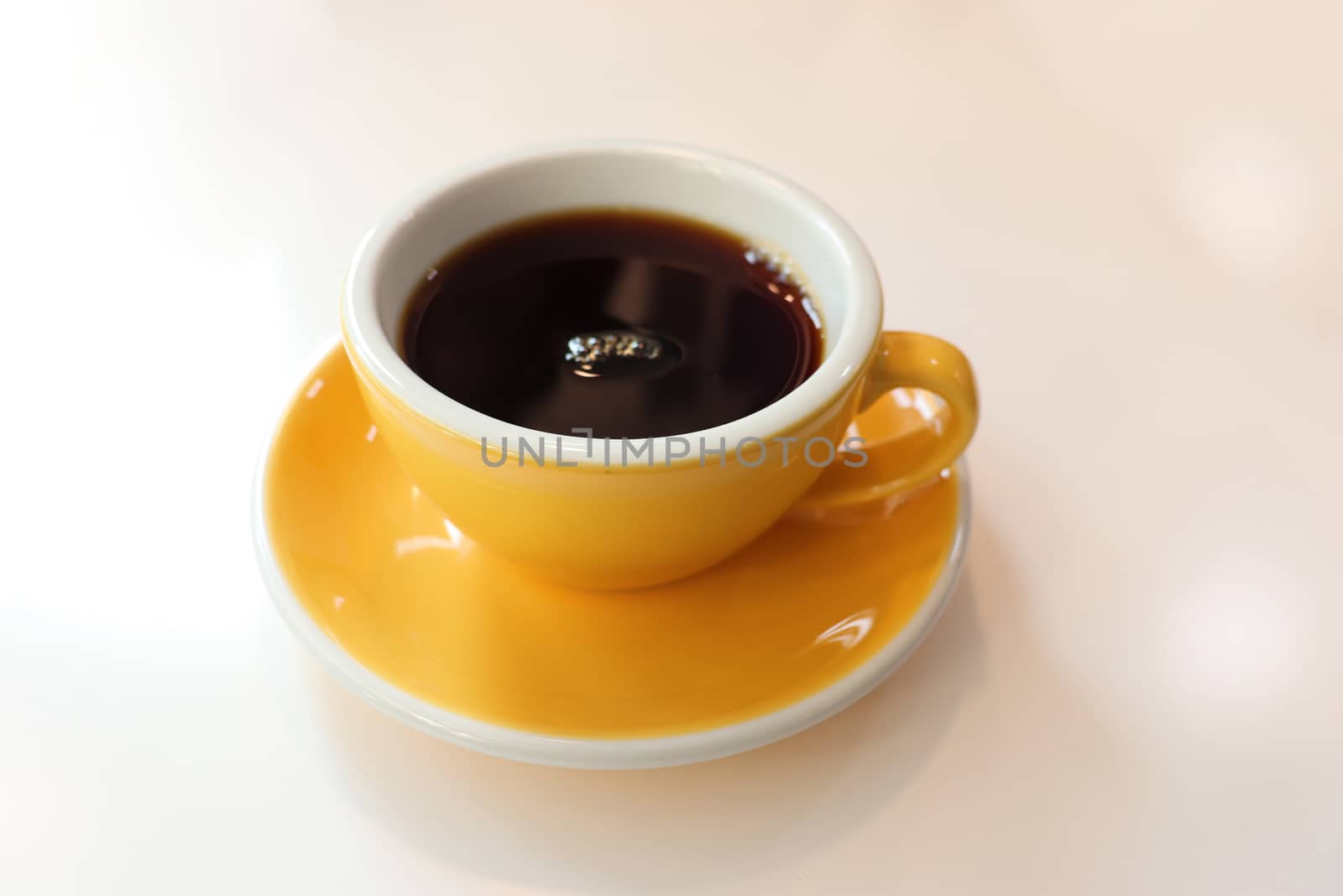 Cup of coffee with latte art on wooden background