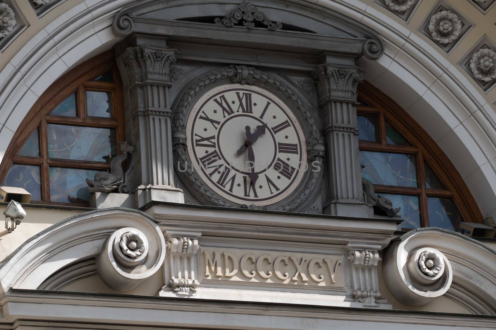 Ancient clock on the facade of the house summer