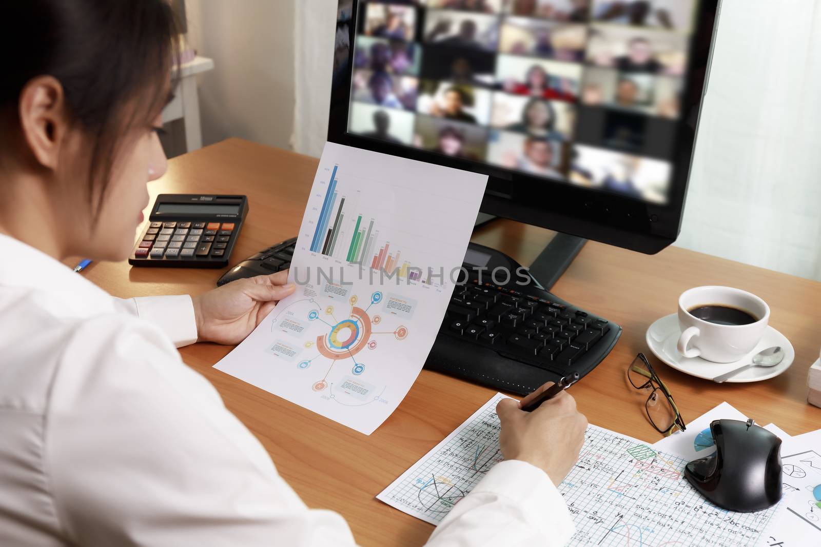 Asian business women working at home online meeting with video conference on computer. Business people using computer online meeting and speaking with team group.