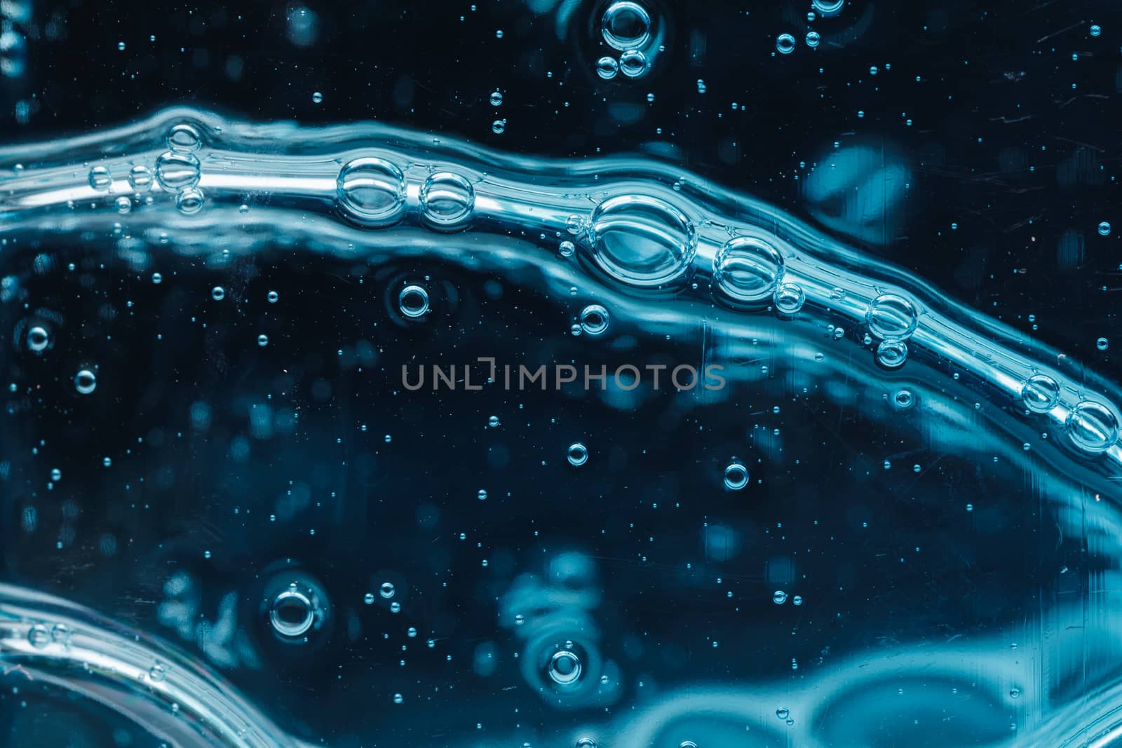 abstract liquid soap bubbles blue background