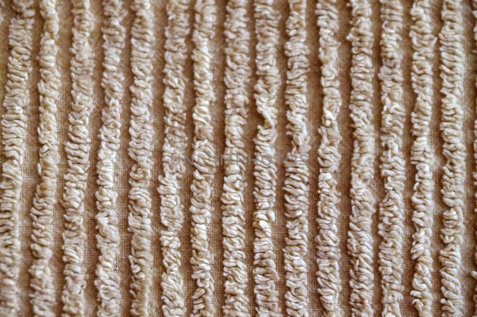 texture of beige ribbed material for background close-up