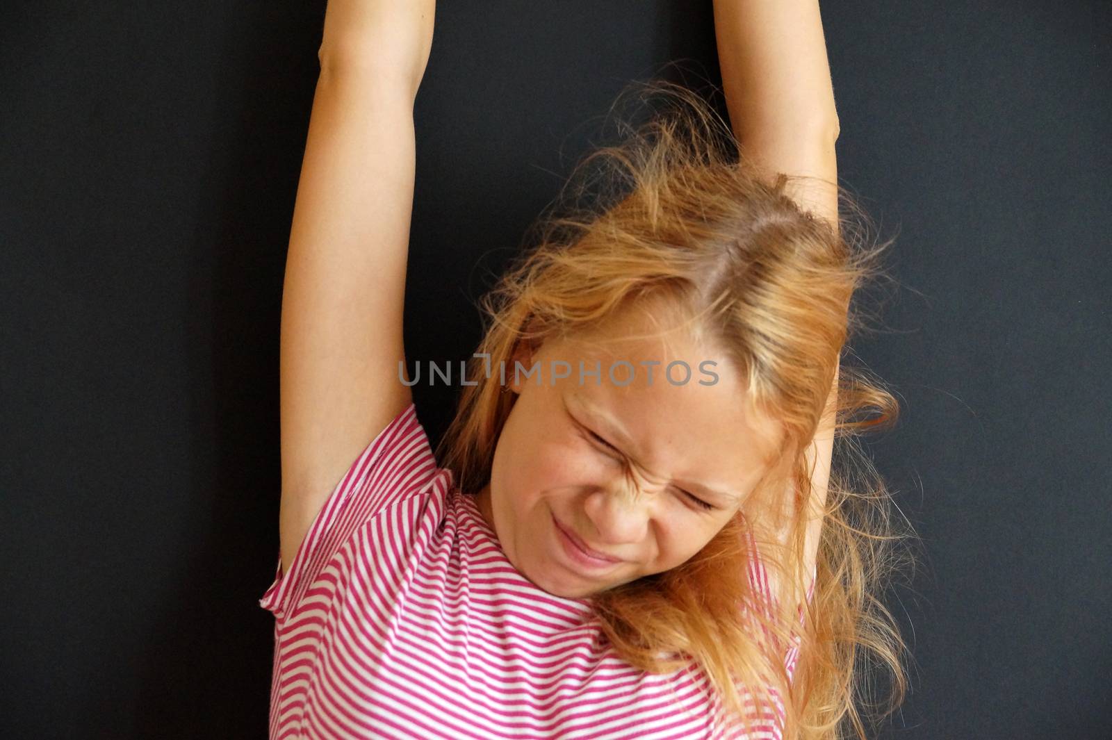 teenage girl just woke up and stretching, portrait on black background by Annado