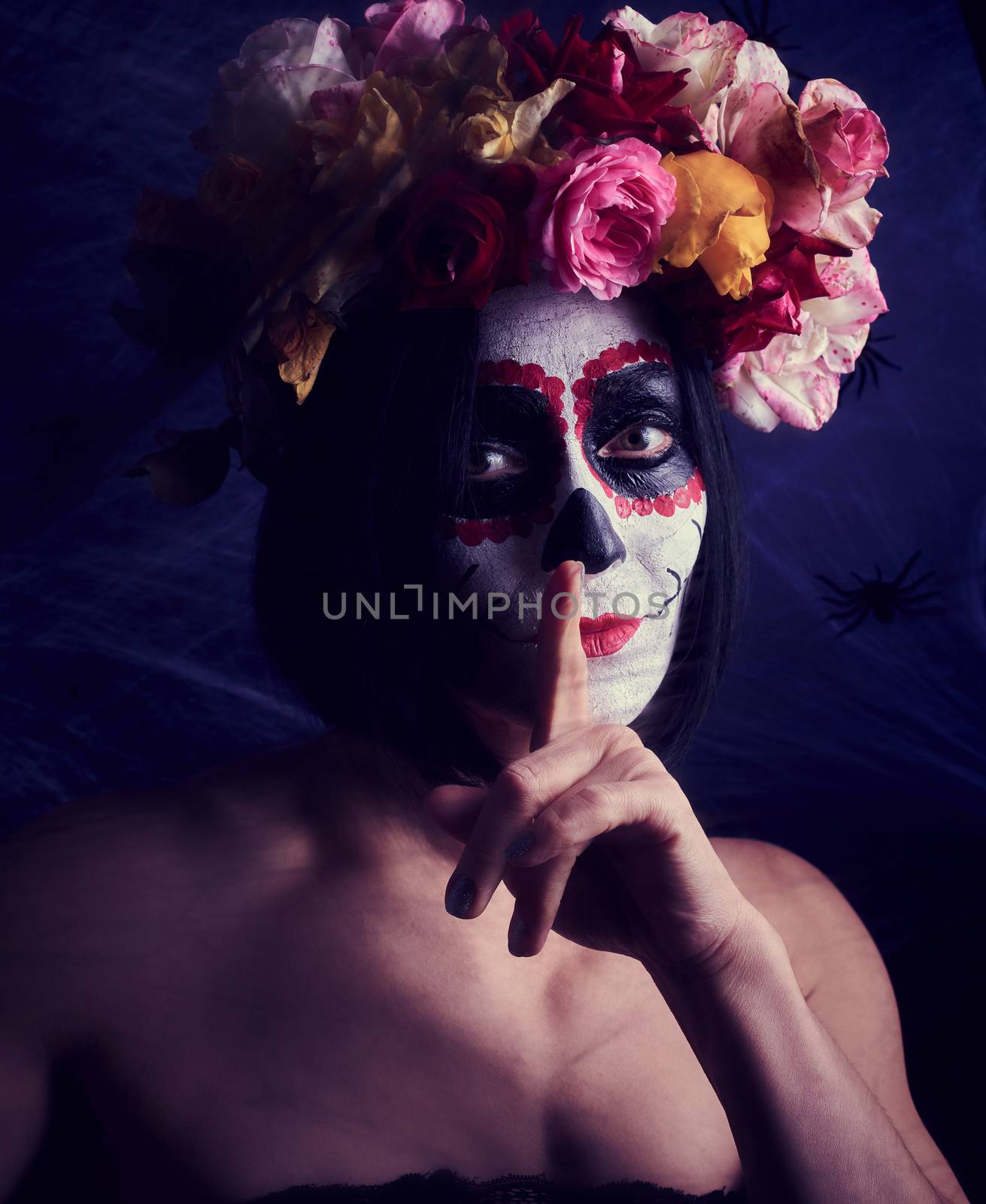 woman of caucasian appearance is dressed in a wreath of multi-colored roses. Sugar skull Halloween Makeup, Calavera Catrina