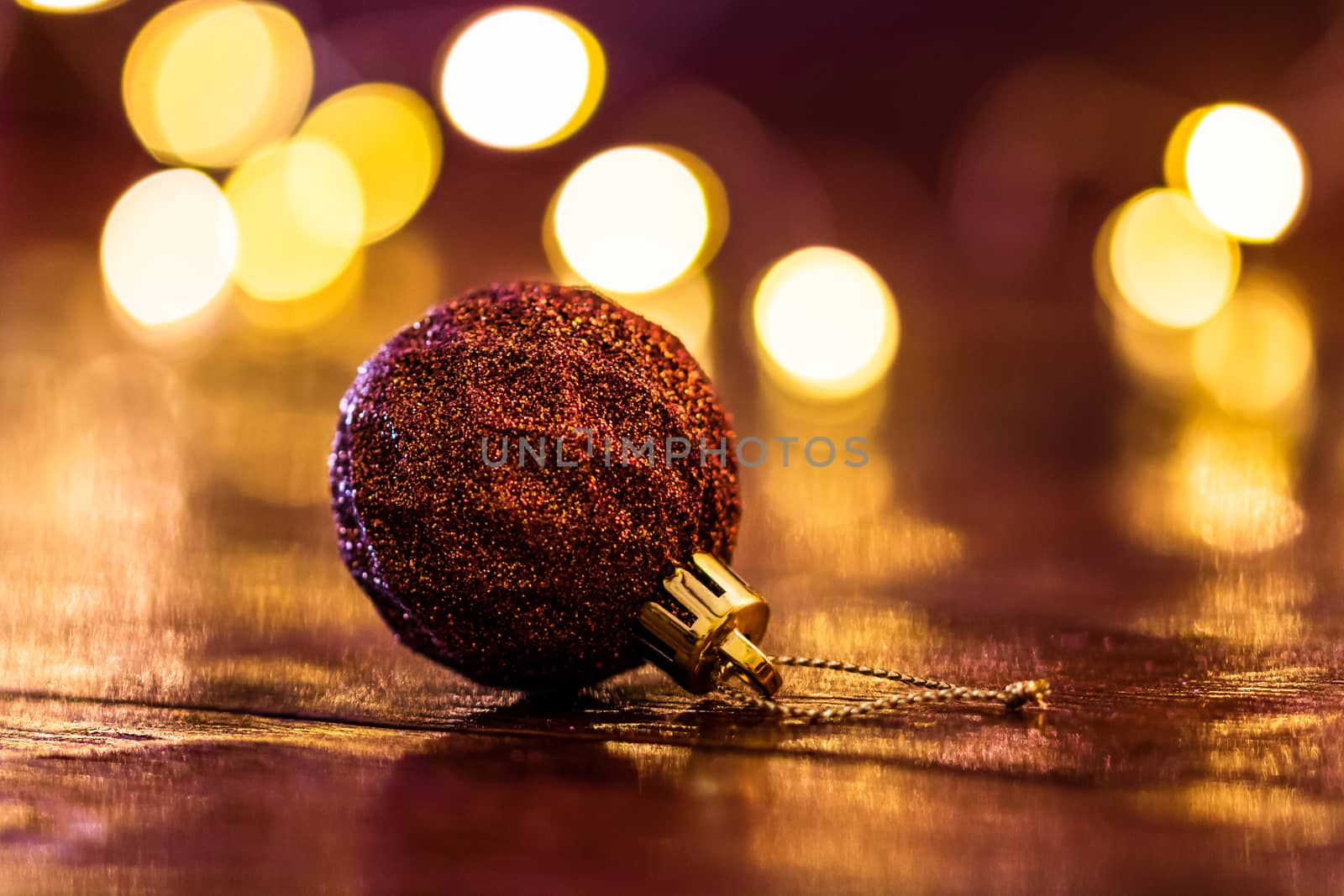 Colorful Christmas ball isolated on blurred and shiny background of lights. Christmas baubles isolated.