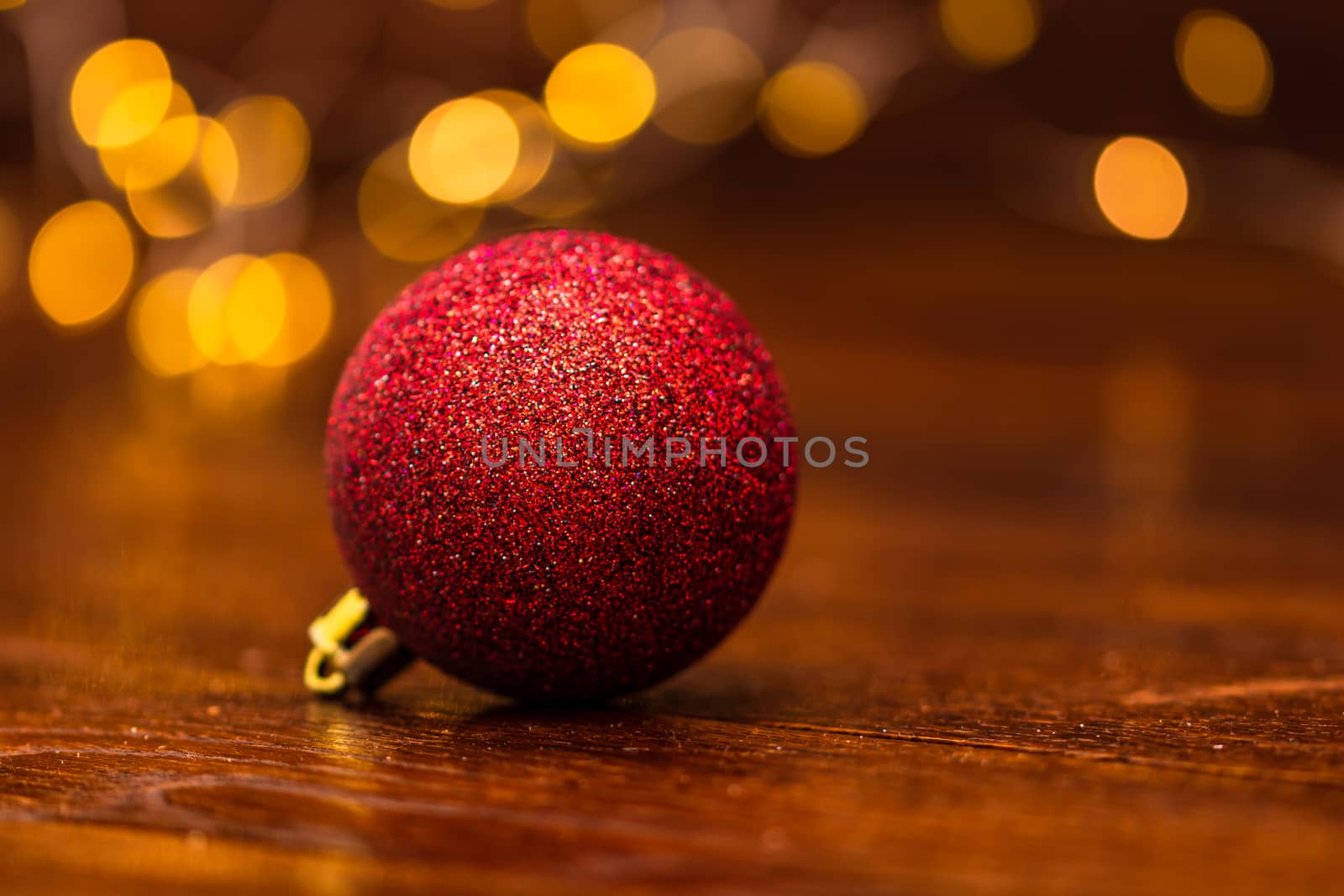 Colorful Christmas ball isolated on blurred and shiny background of lights. Christmas baubles isolated.