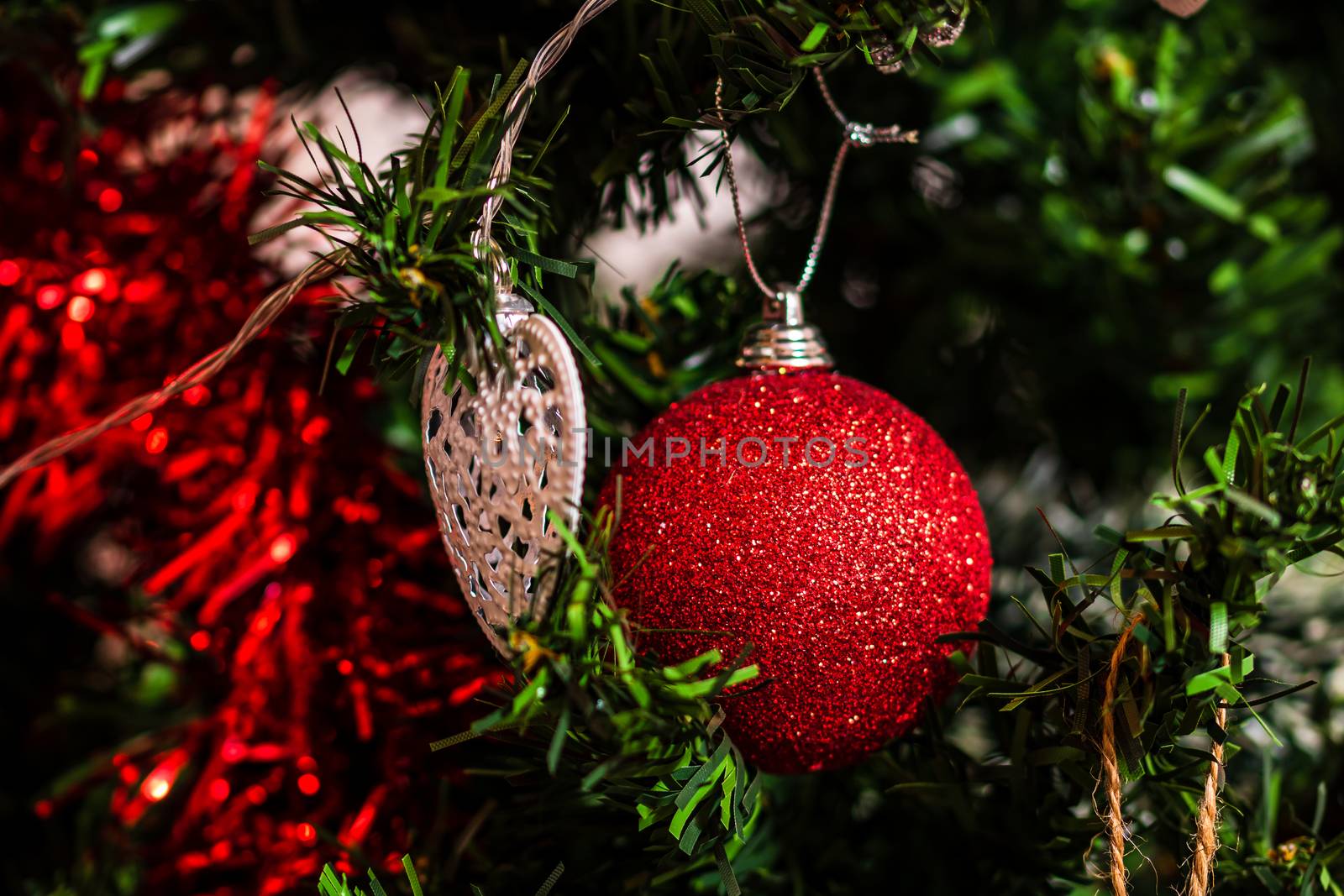 Christmas hanging decorations on fir tree. Decorated Christmas tree. Fir branch with Christmas baubles decorations.