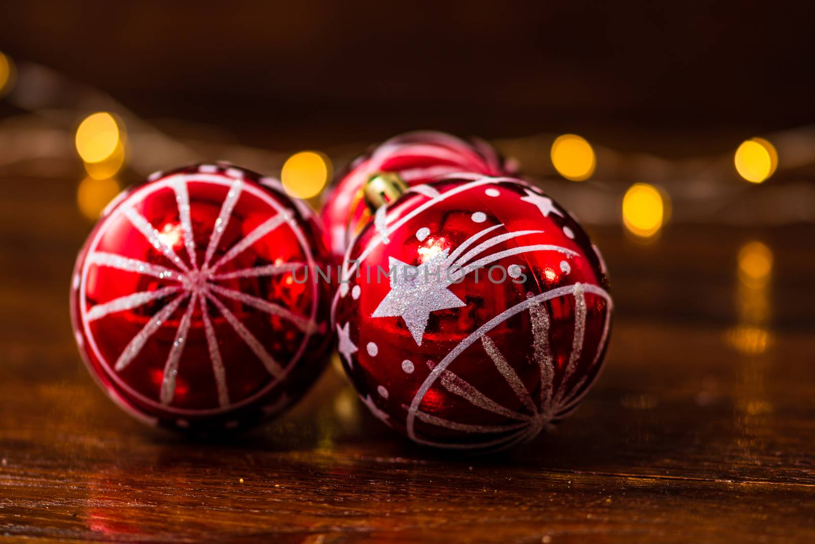 Red Christmas balls isolated on blurred and shiny background of lights. Christmas baubles isolated.