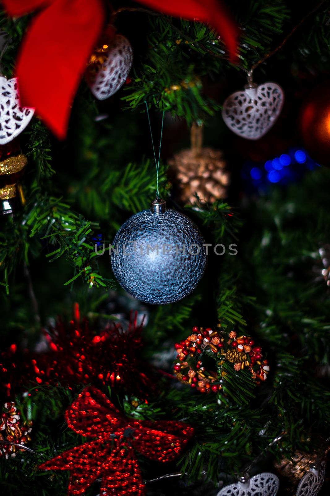 Christmas hanging decorations on fir tree. Decorated Christmas tree. Fir branch with Christmas baubles decorations.