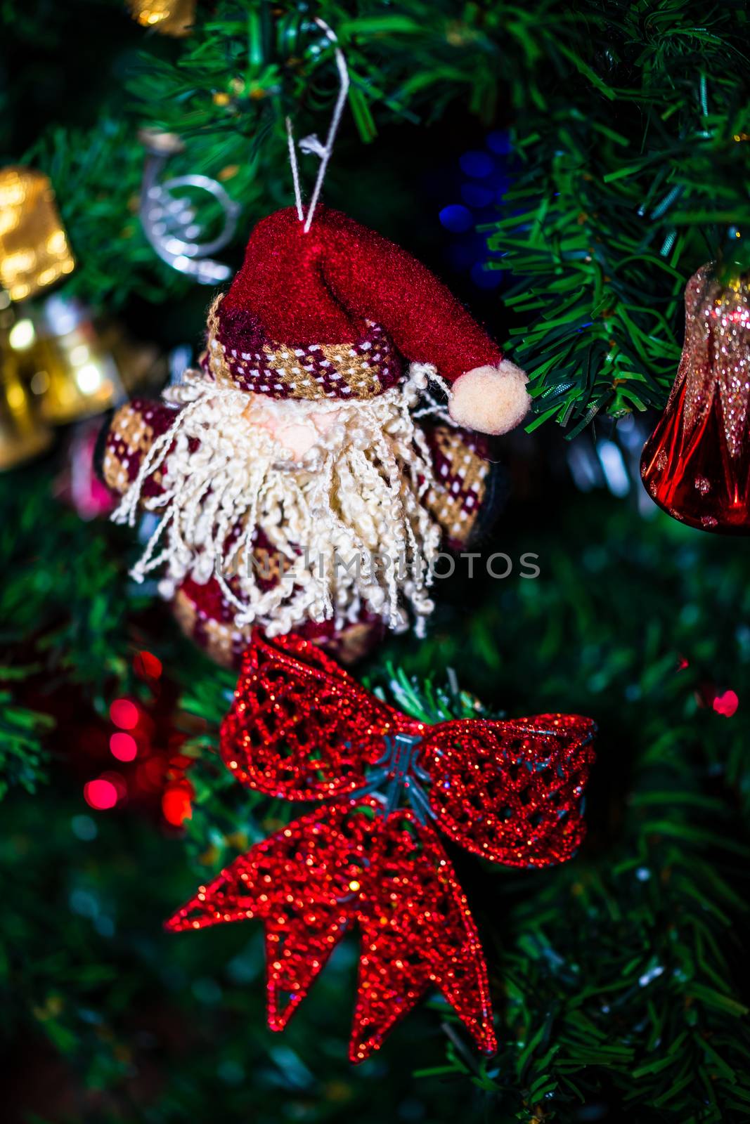 Christmas hanging decorations on fir tree. Decorated Christmas tree. Fir branch with Christmas baubles decorations.