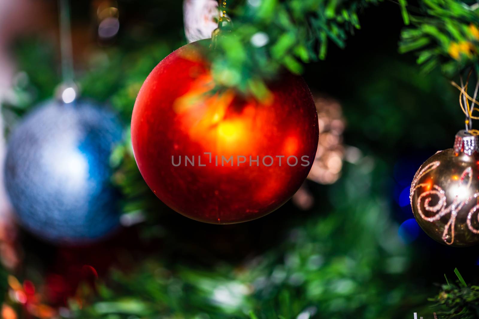 Christmas hanging decorations on fir tree. Decorated Christmas tree. Fir branch with Christmas baubles decorations.