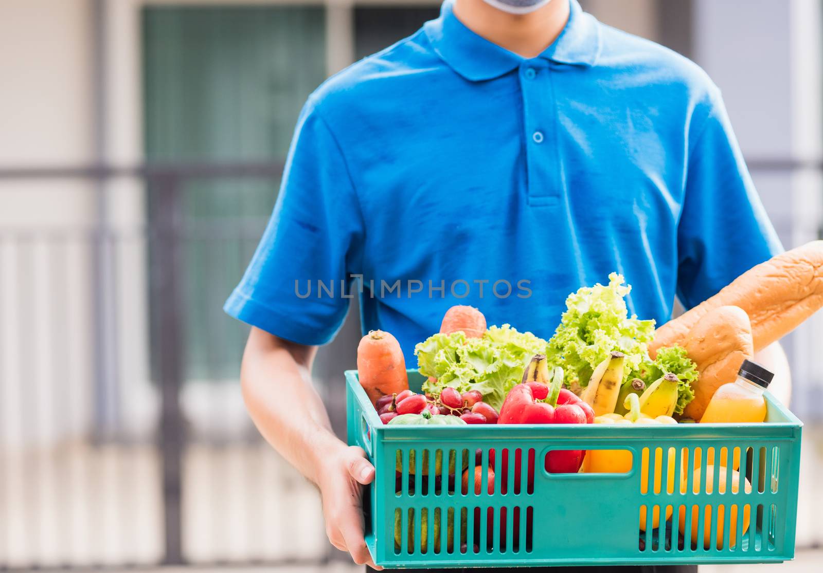 Delivery man wearing face mask protect he delivering fresh food  by Sorapop