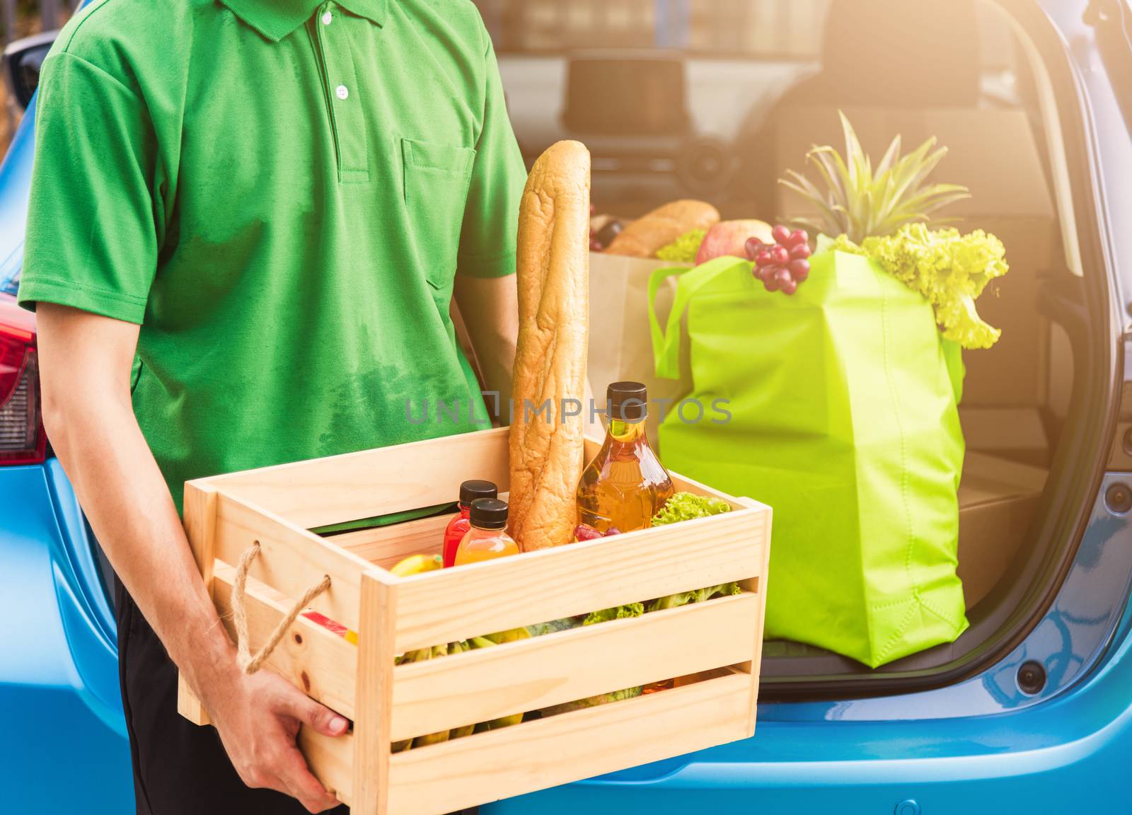 Asian delivery man grocery prepare service giving fresh vegetables food and fruit full in wooden basket on back car to send woman customer at door home after pandemic coronavirus, Back to new normal