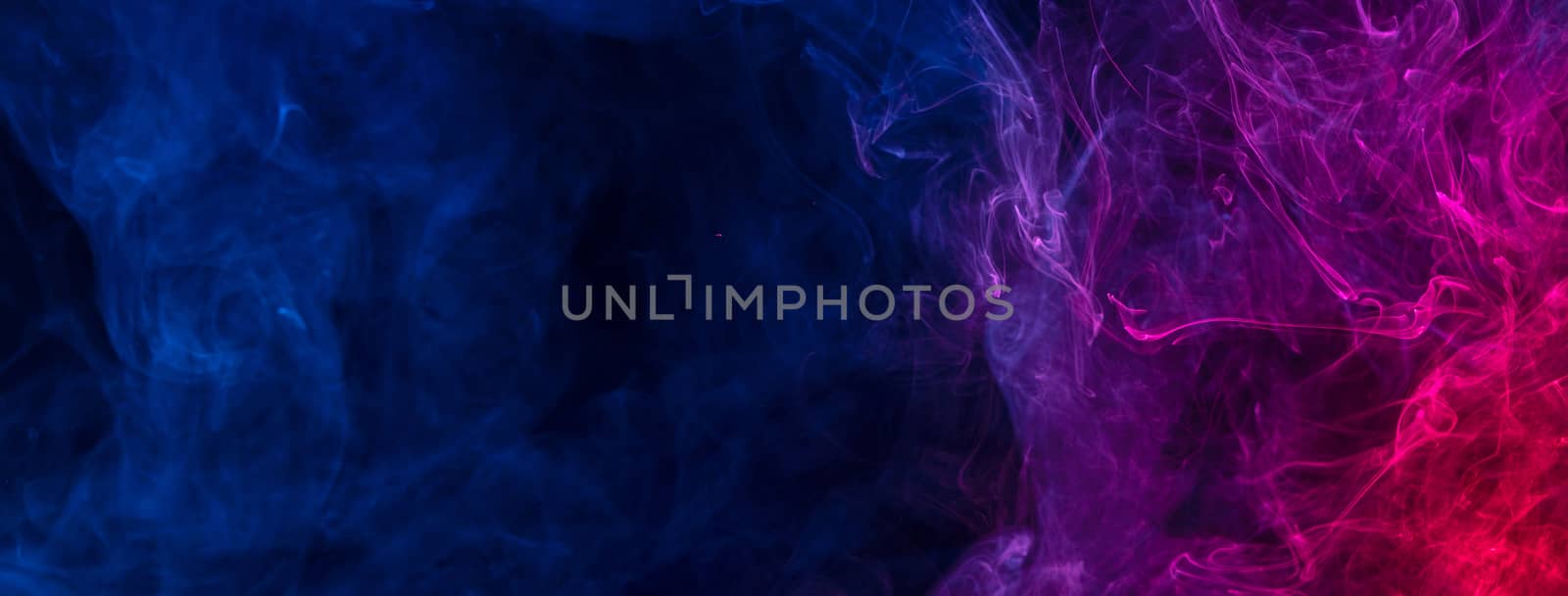 Conceptual image of multi-colored smoke isolated on dark black b by ROMIXIMAGE