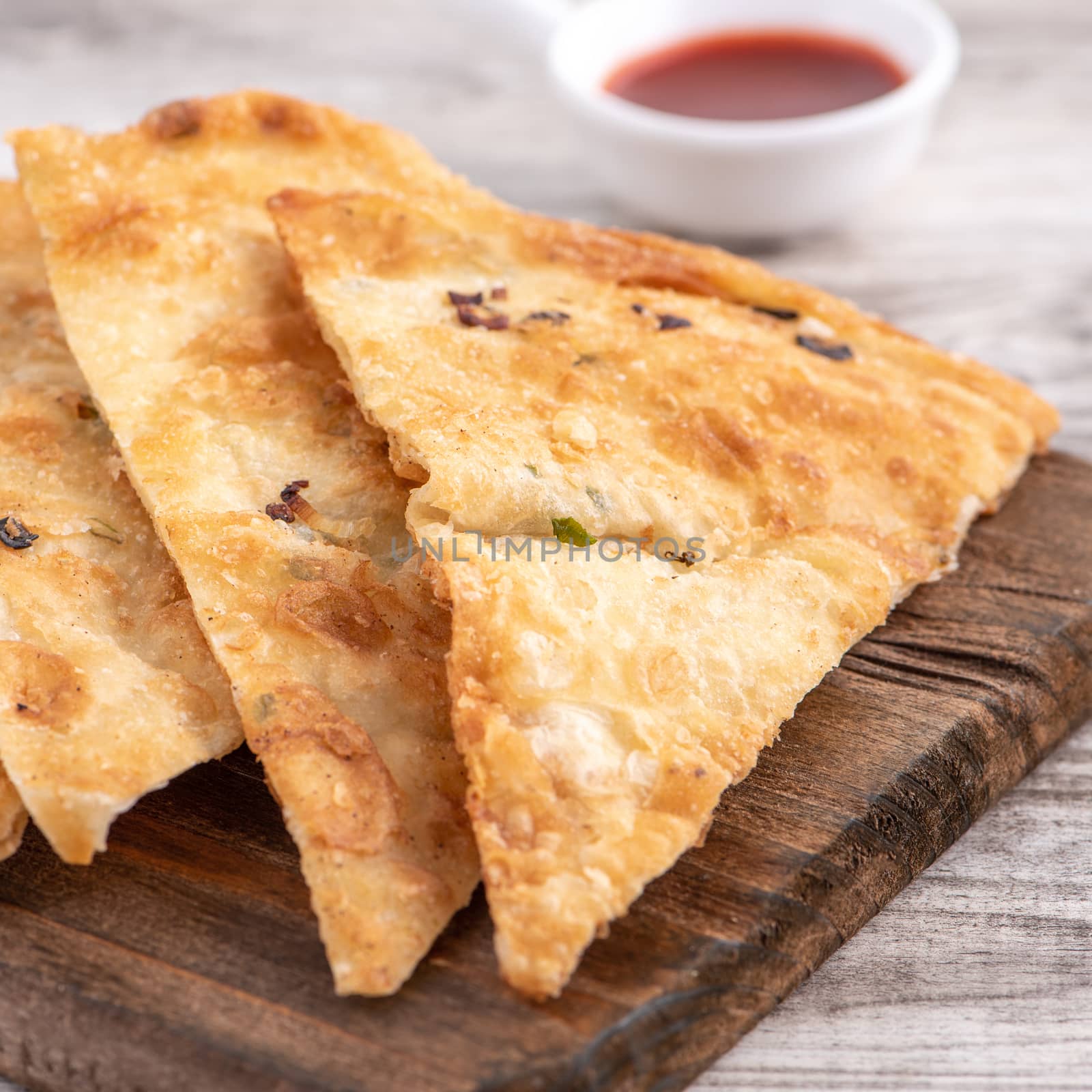 Taiwanese food - delicious flaky scallion pie pancakes on bright by ROMIXIMAGE