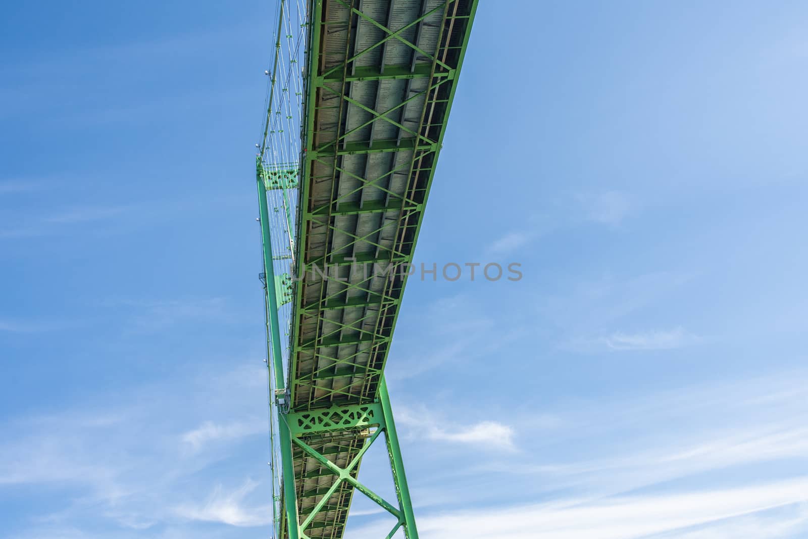 Fragments of the metal structures of the transport bridge and its support structures, photographed from below and from the sides