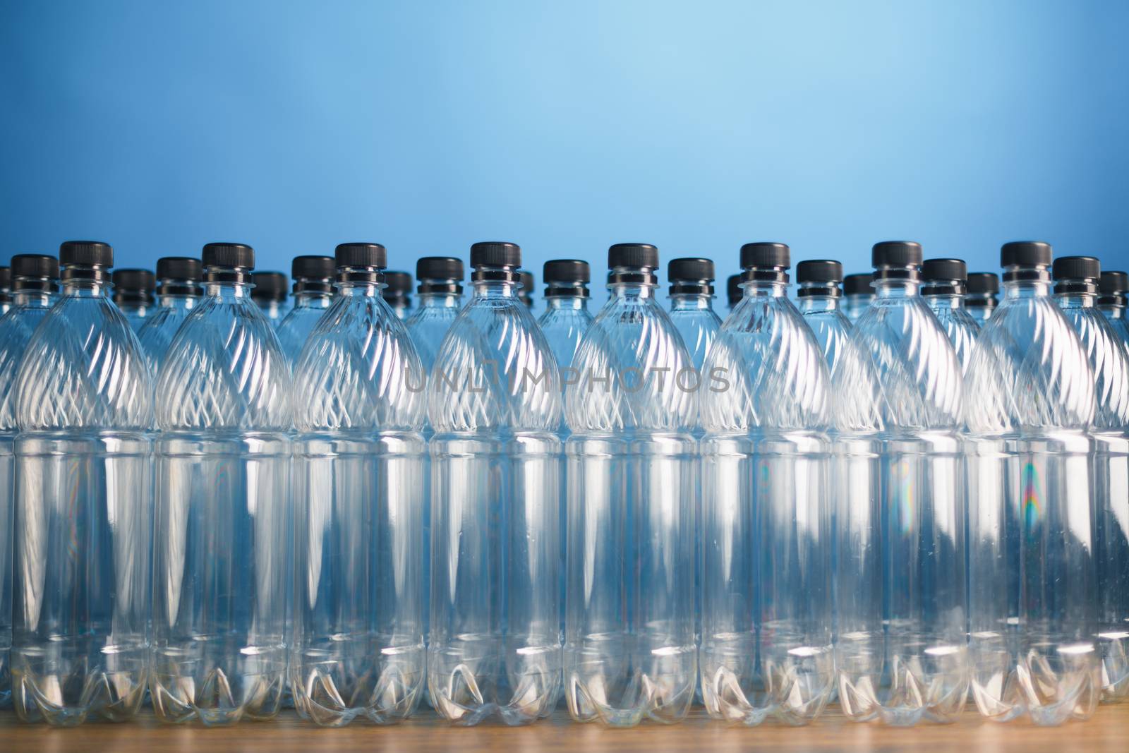 empty plastic bottles on blue background by nikkytok