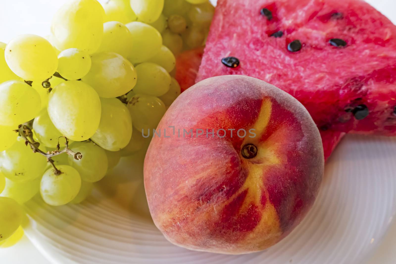 peaches, watermelons, and grape fruits on plate