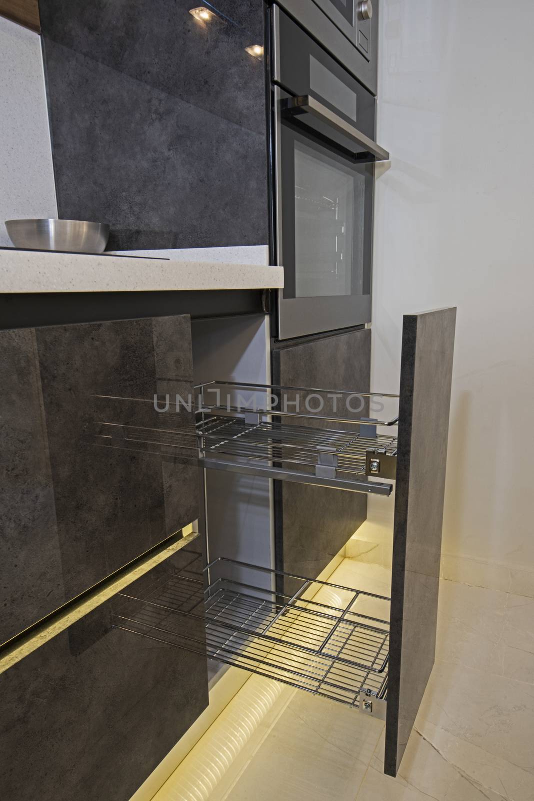 Interior design decor of kitchen in luxury apartment showing closeup detail of sliding cupboard with shelves