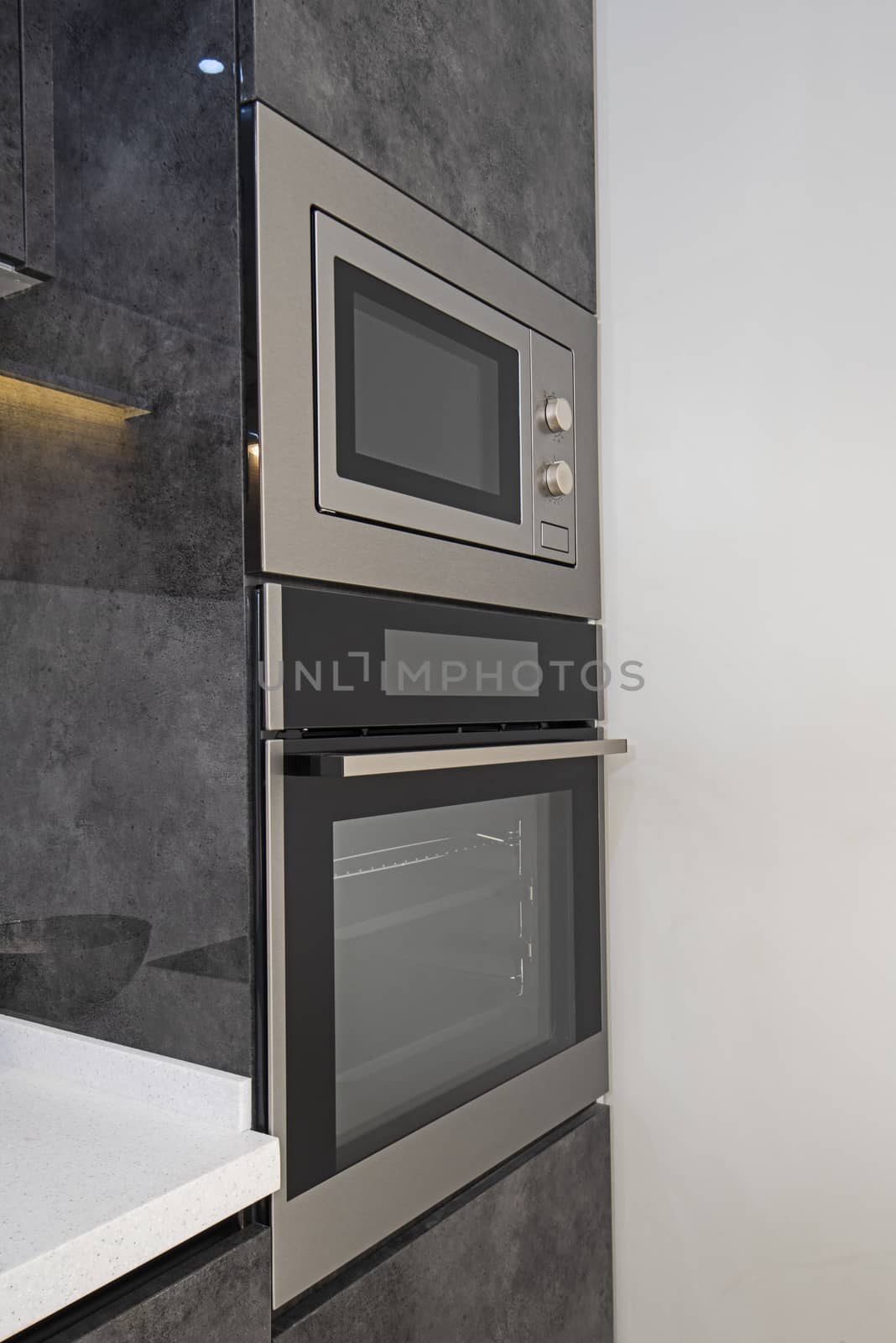 Interior design decor showing modern kitchen cooker oven with cupboards in luxury apartment showroom