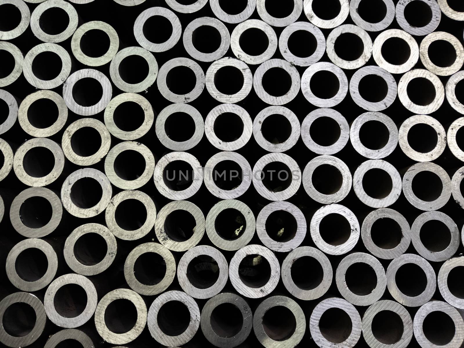 abstract dark industrial background of sawed steel pipes ends - flat and full frame.