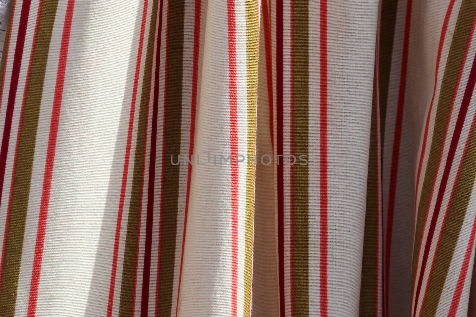 Detailed close up view on samples of cloth and fabrics in different colors found at a fabrics market.