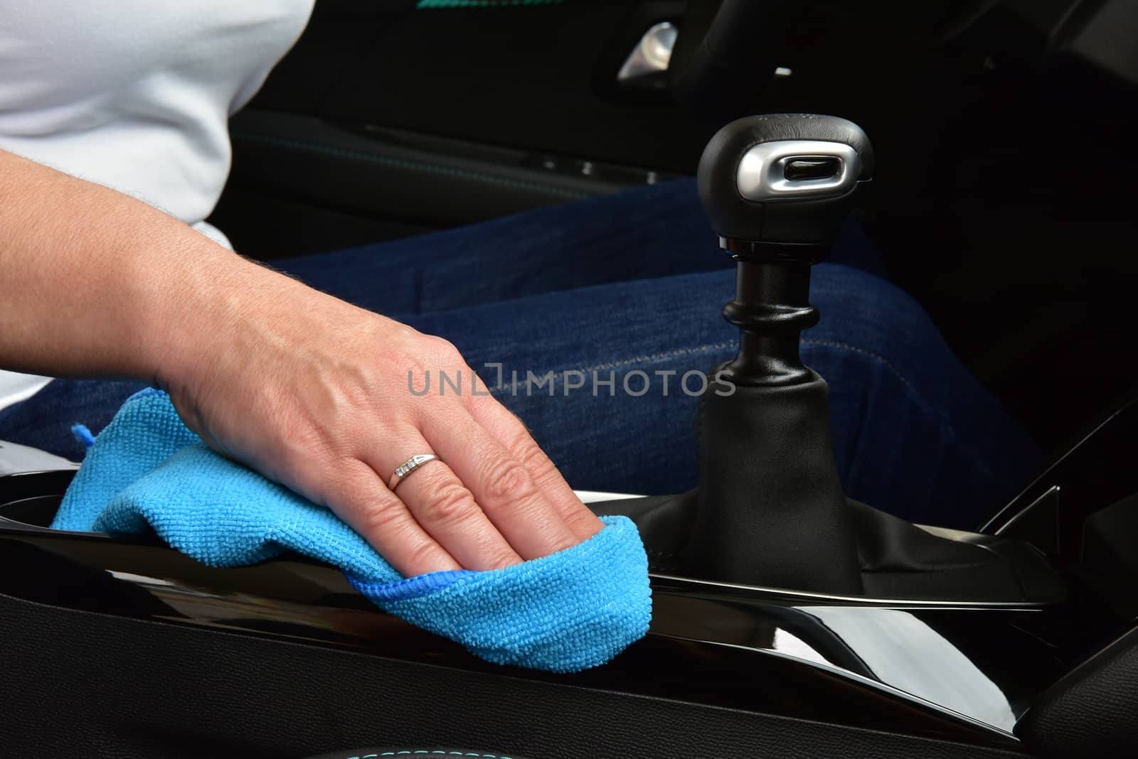 Hand cleaning Interior modern car with Microfiber and cleaning console car