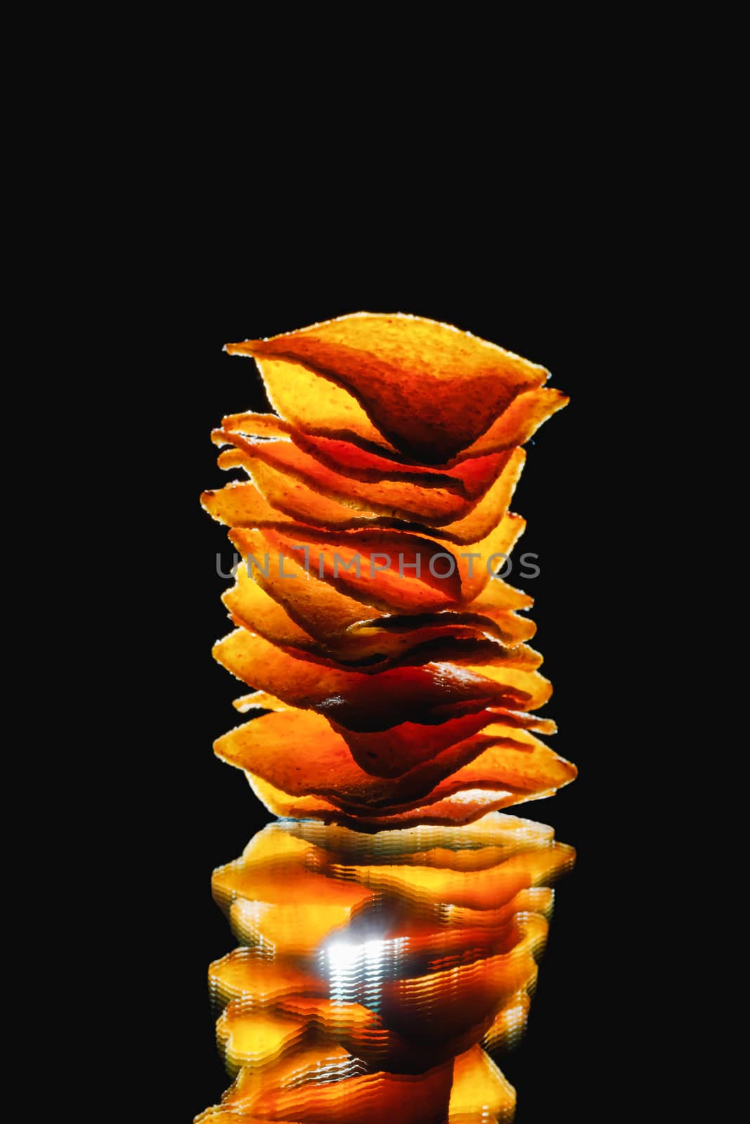 mexican nachos tortilla chips stack, black background by nikkytok