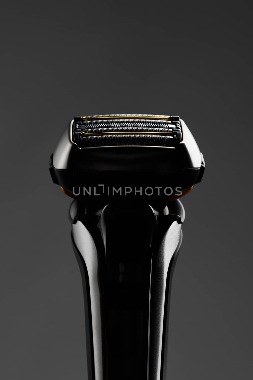 electric razor foil shaver mesh and blades, close-up view, gray background