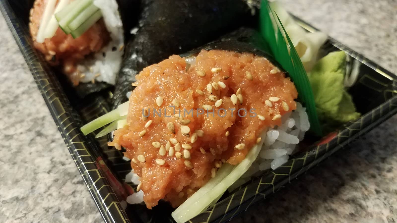 spicy tuna handroll sushi with seeds in container by stockphotofan1