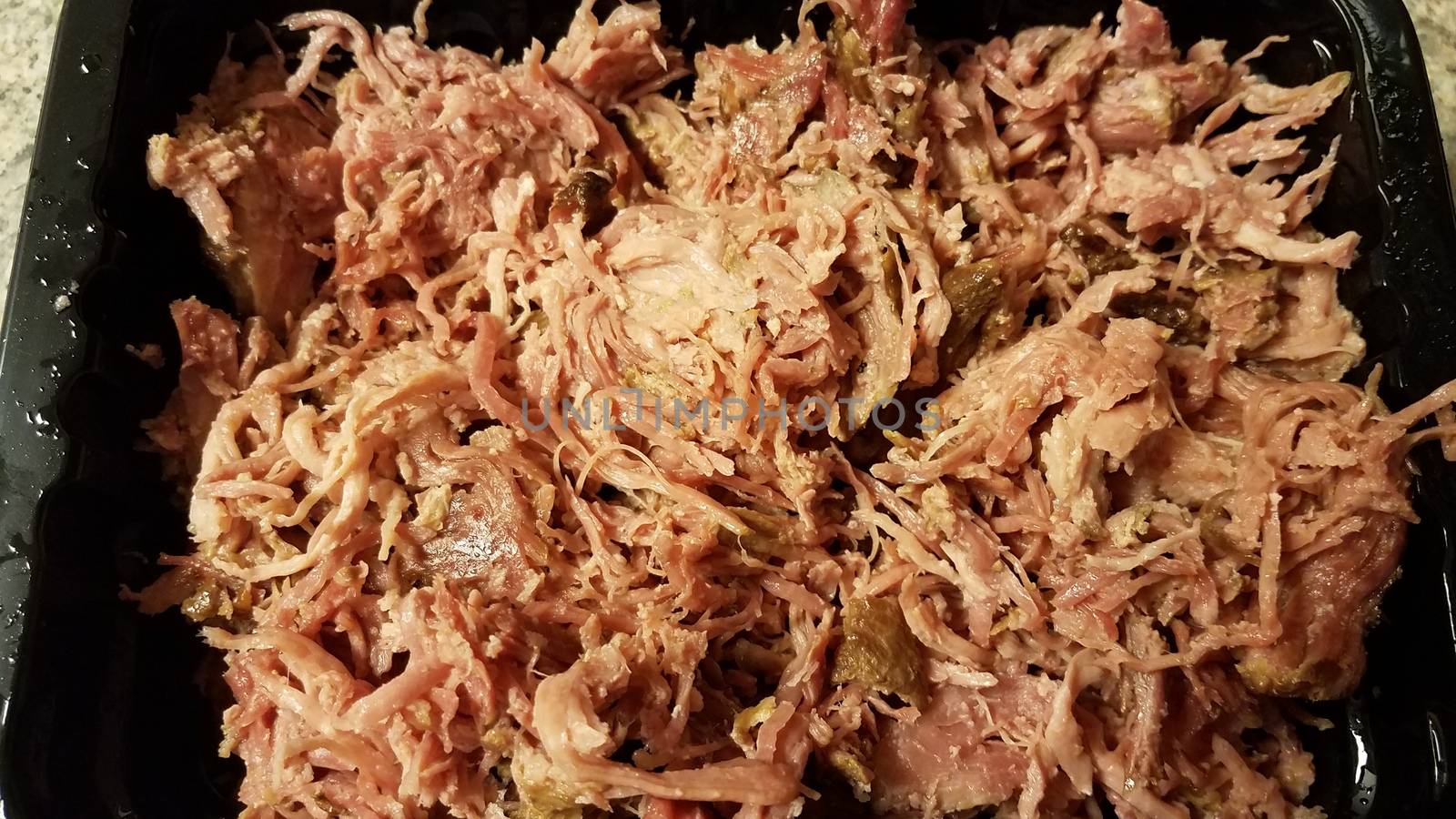 pile of savory pulled pork meat in container by stockphotofan1