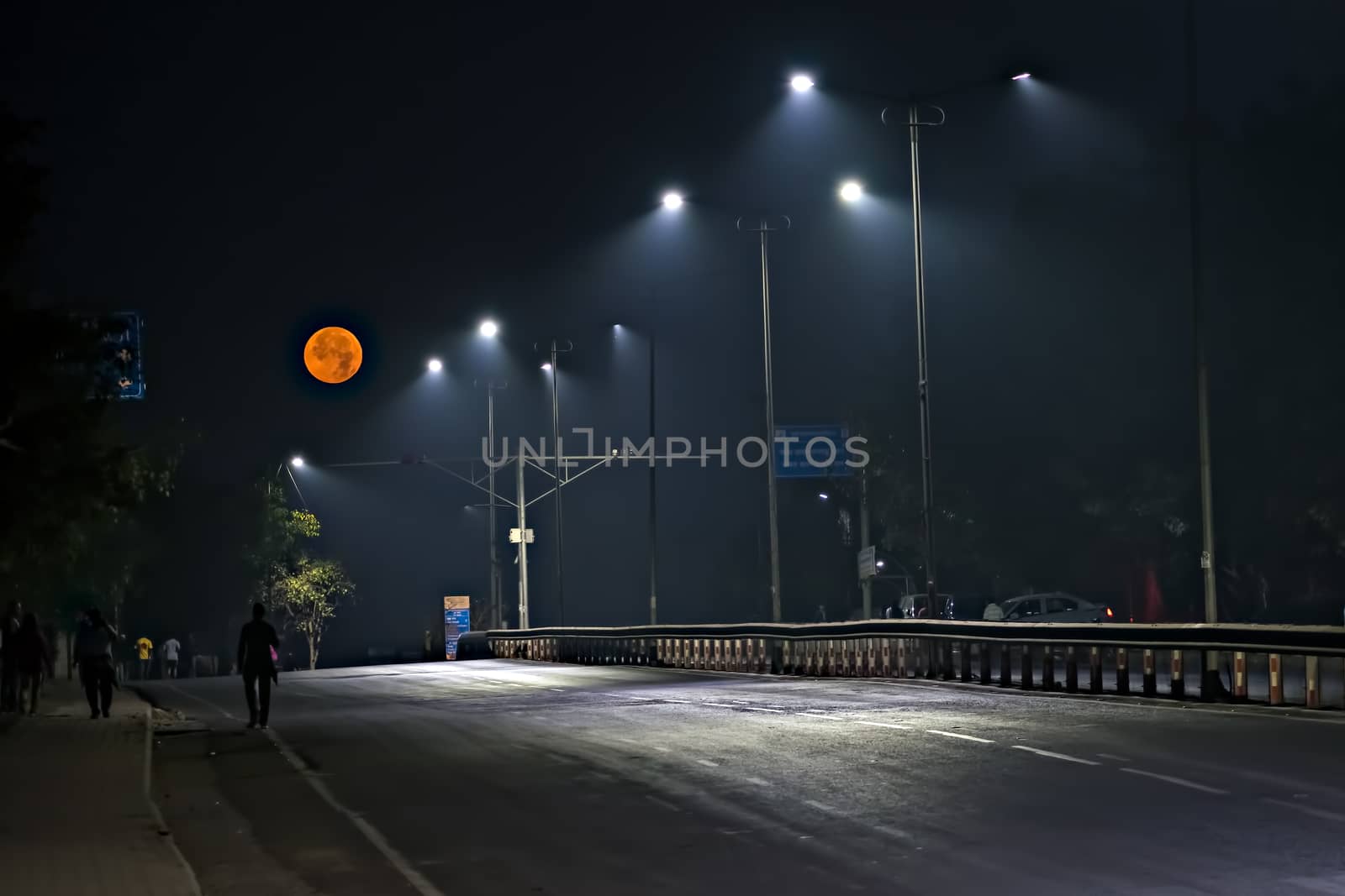 Super-moon image with empty street early in the morning. by lalam