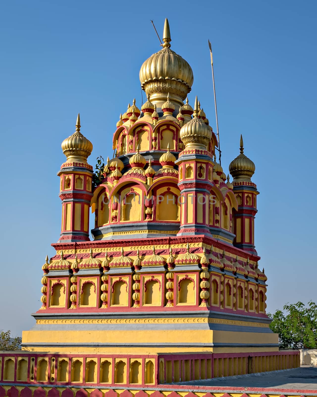 Colorful dome of oldest heritage structure in Pune - Parvati temple on a clear blue sky background on Parvati hill, Pune.