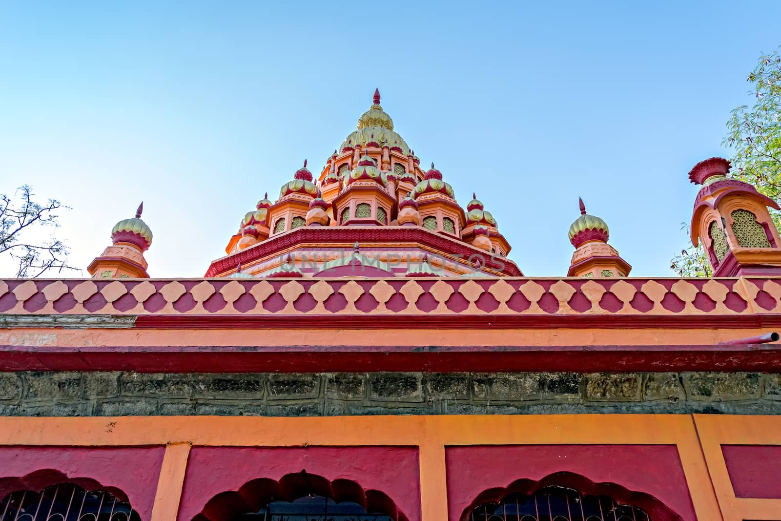 Close up of dome of Parvati temple on a clear blue sky background. by lalam