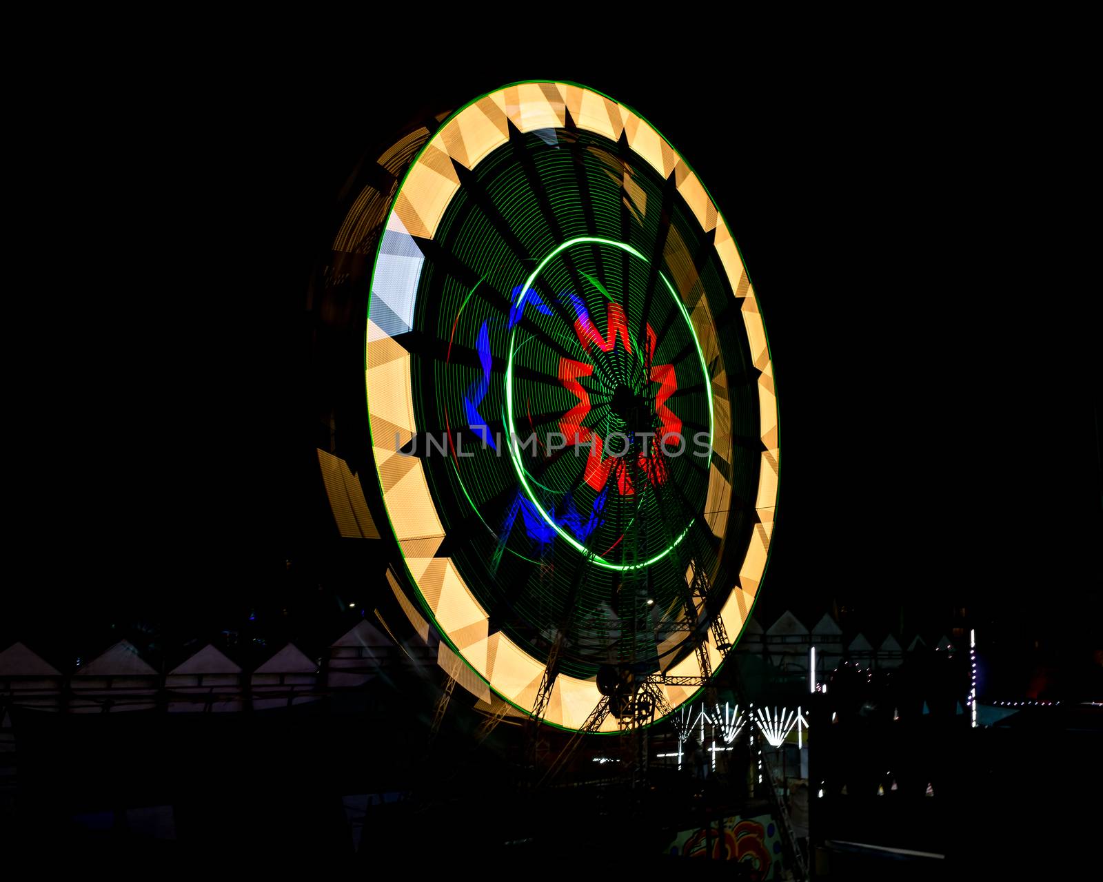 Slow shutter, night image of a spinning giant wheel in funfair in Pune, India. by lalam