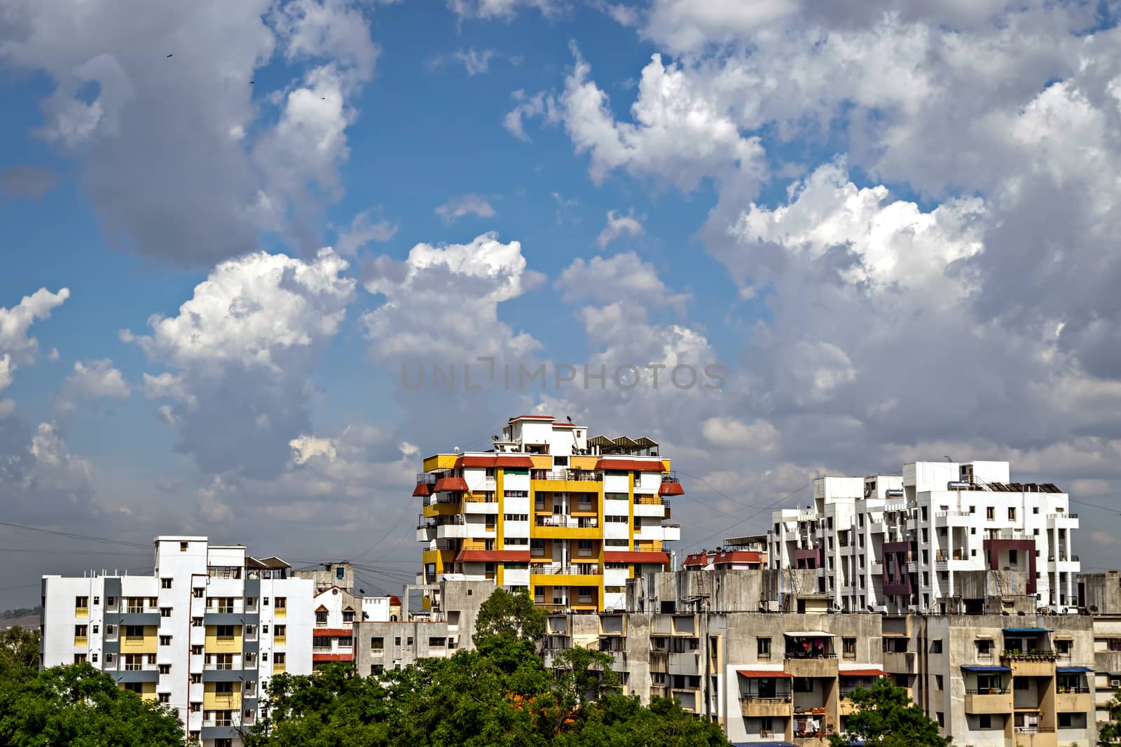 Yellow and red highrise building with beautiful cloudscape. by lalam
