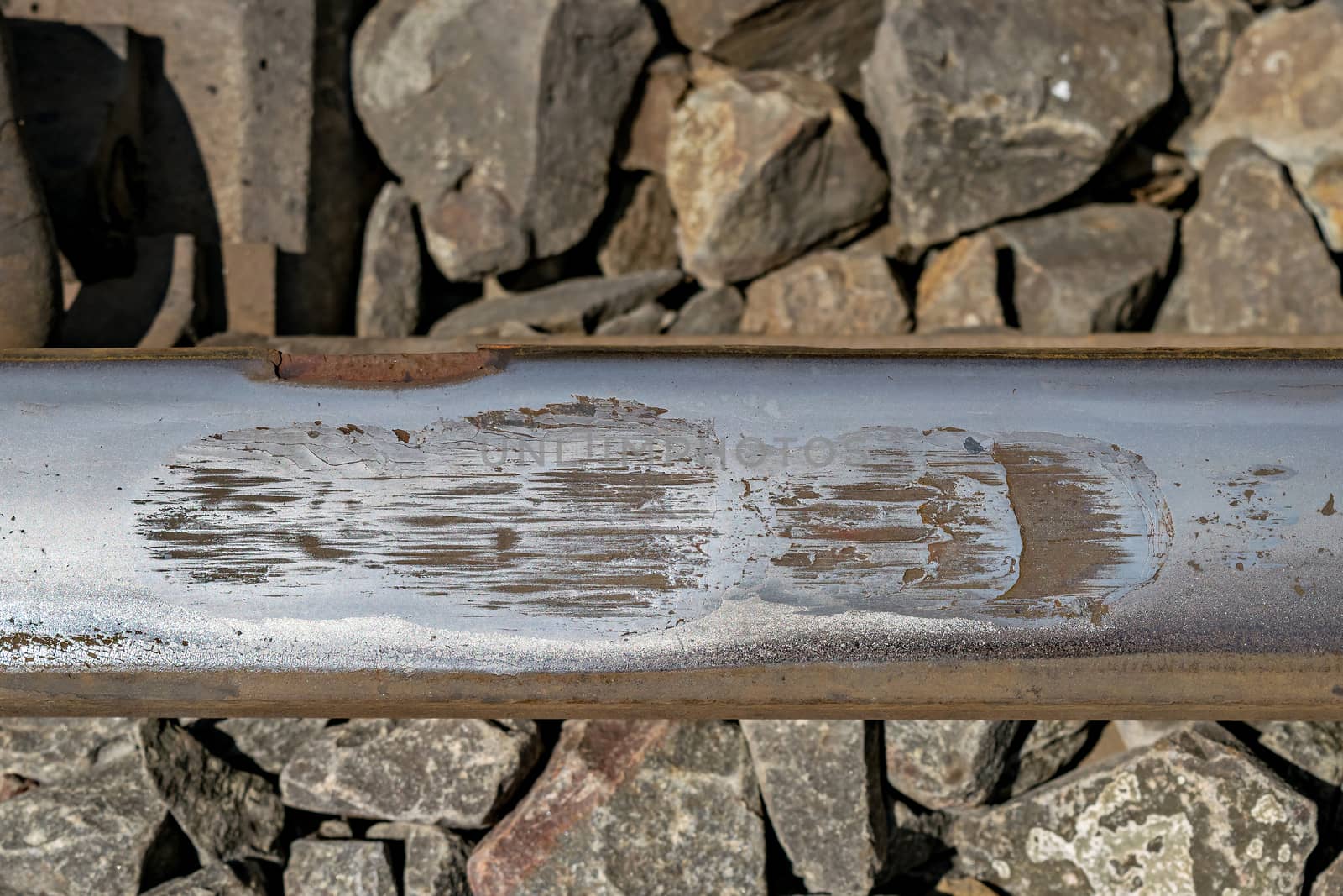 Close up image of eroded steel rail due to friction. Steel rails often get eroded due wheel slippage & friction of heavy locomotive as they try to pull heavy trains.