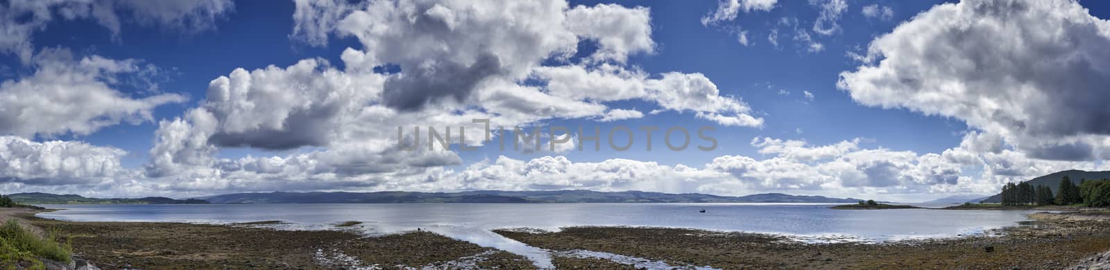 Panoramic view of rocks and boulders on the shore of the Firth of Clyde on the West coast of Scotland